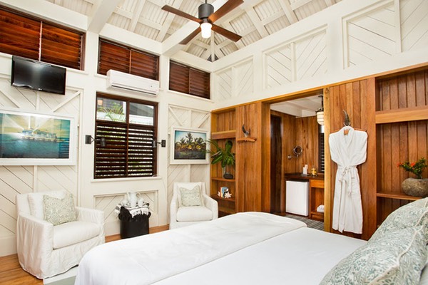 interior shot of Guest Cottage at Mahogany Bay Village shows louvered Belizian windows and interior hardwood walls that double as storage units