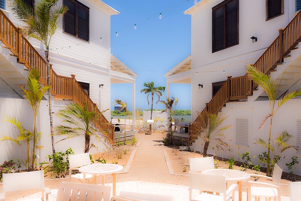 Rum & Bean and Mahogany Bay Village sales office share an inner courtyard under the blue Belizean sky