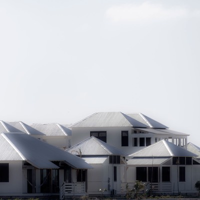 corrugated metal roofs of Mahogany Bay Village glow white as they bounce the sun's heat back to the tropical sky on Ambergris Caye in Belize