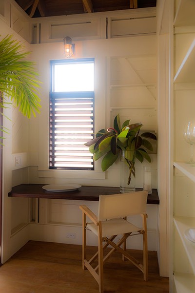 work space surrounded by open wood shelving carved into the walls of the Dream Suite at Mahogany Bay Village on Ambergris Caye, Belize