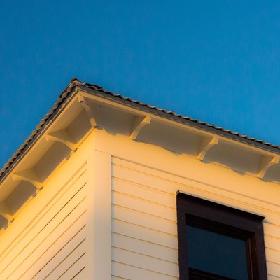 evening sun paints scroll-cut rafter tails golden at Mahogany Bay Village, rising from the sands of Ambergris Caye in Belize